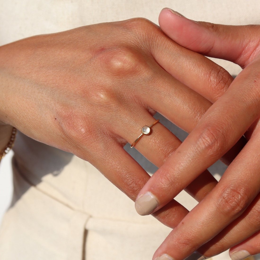 Token Jewelry's Moonstone Ring features a simple band with a moonstone gemstone bezeled to it.