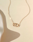 14k solid gold linked hammered circle pendent necklace on a dainty chain in the sunlight