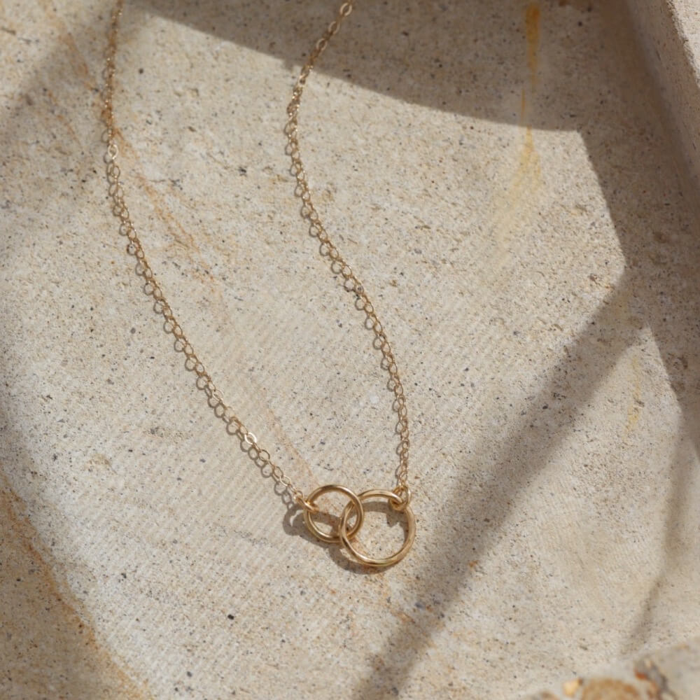 14k solid gold. An heirloom you'll pass along in your family through generations, token jewelry heirloom collection, solid gold, timeless, everyday jewelry, solid gold unity necklace, classic, handmade, made in eau claire, wisconsin, USA, woman owned business, small business