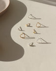 small heart studs with a patterned border, on a ceramic dish