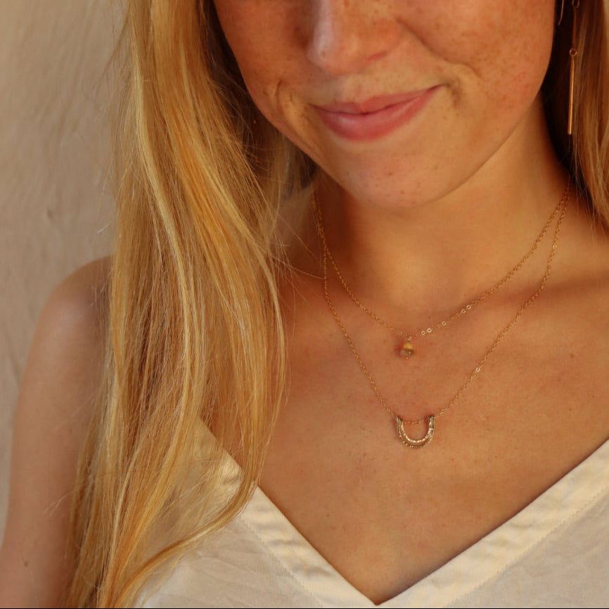 model wearing 14k gold fill hammered pendant on a 14k gold fill dainty necklace chain