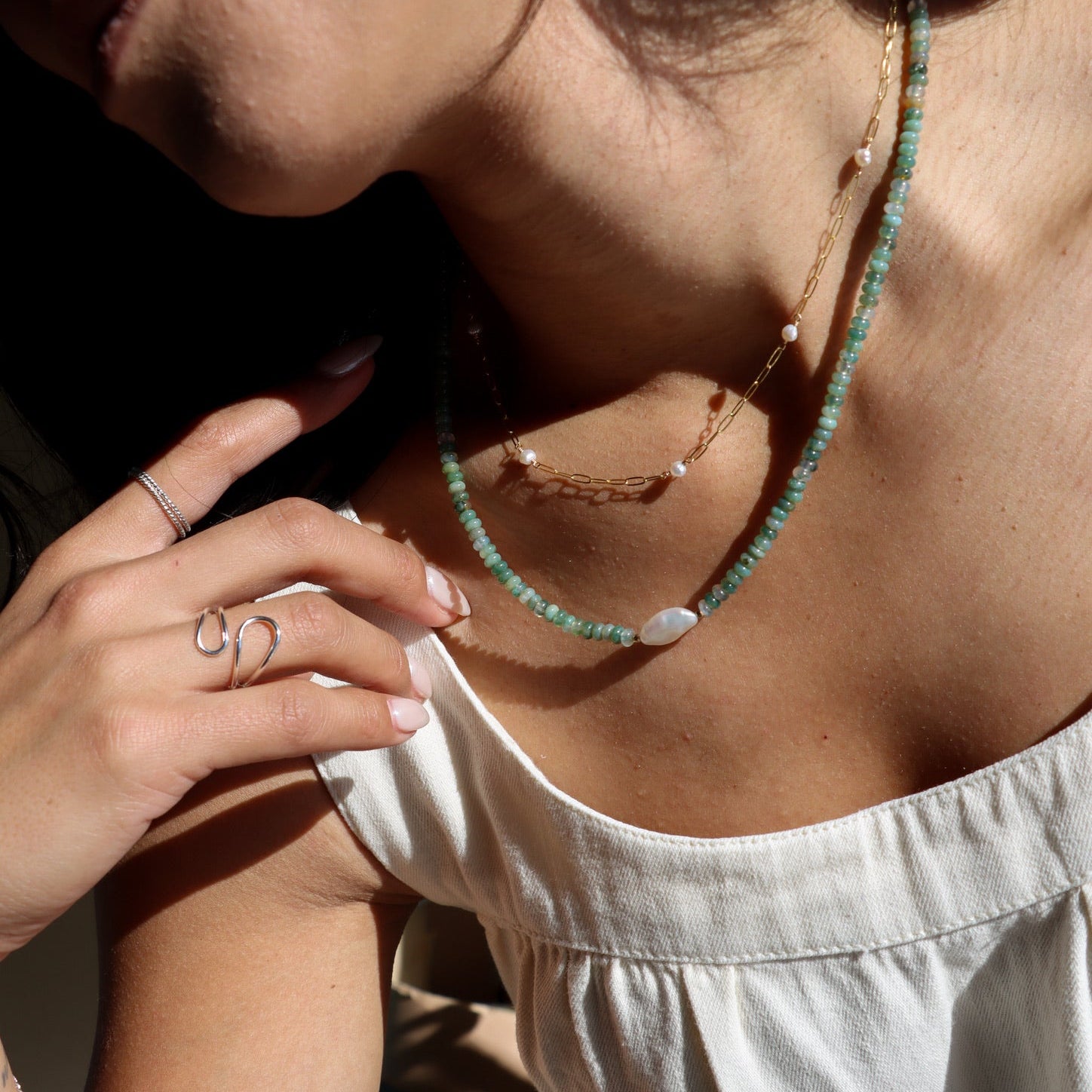 model wearing beaded necklace with pearl and moss agate gemstone beads with chain and pearl necklace