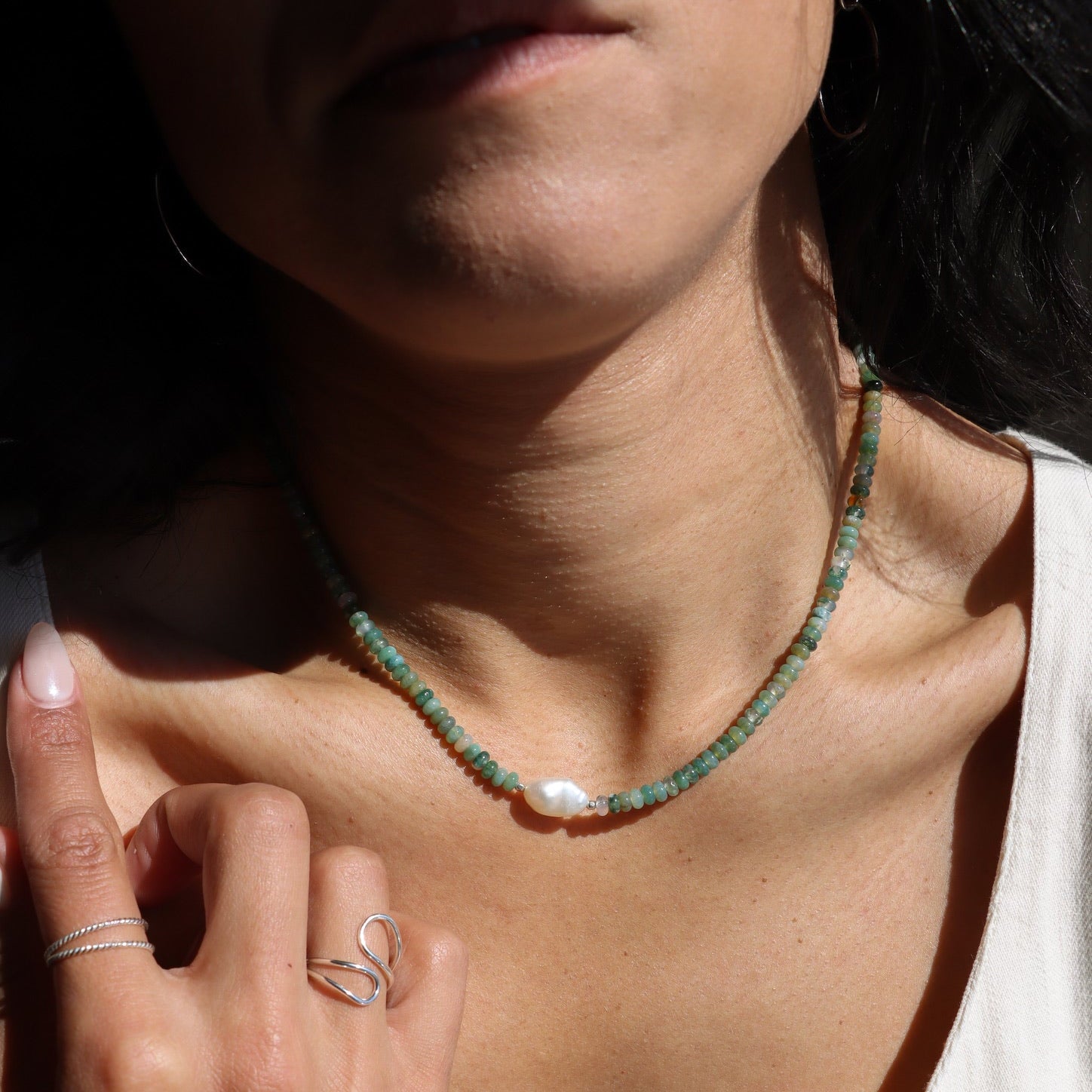 model wearing beaded necklace with pearl and moss agate gemstone beads