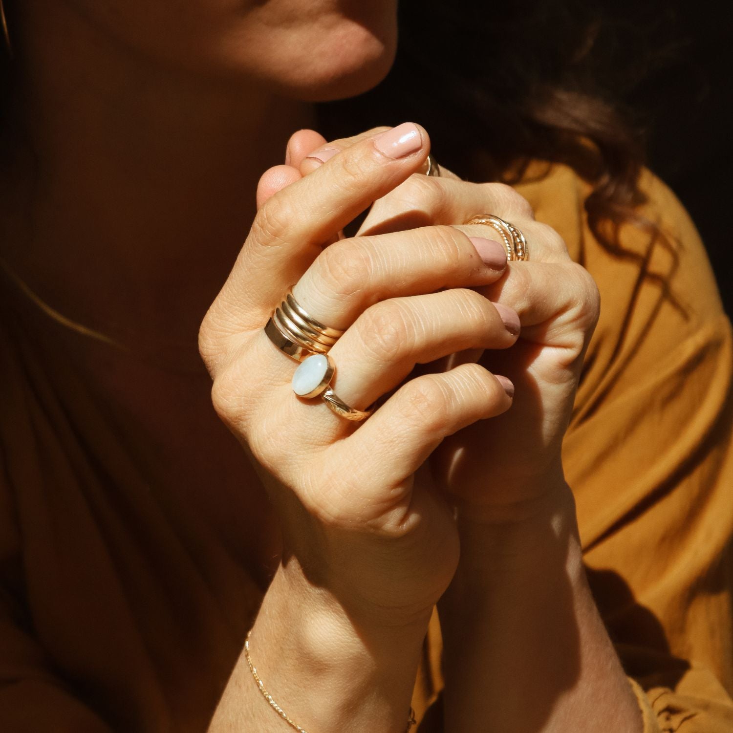 model wearing 14k gold fill rings paired with an oval moonstone
