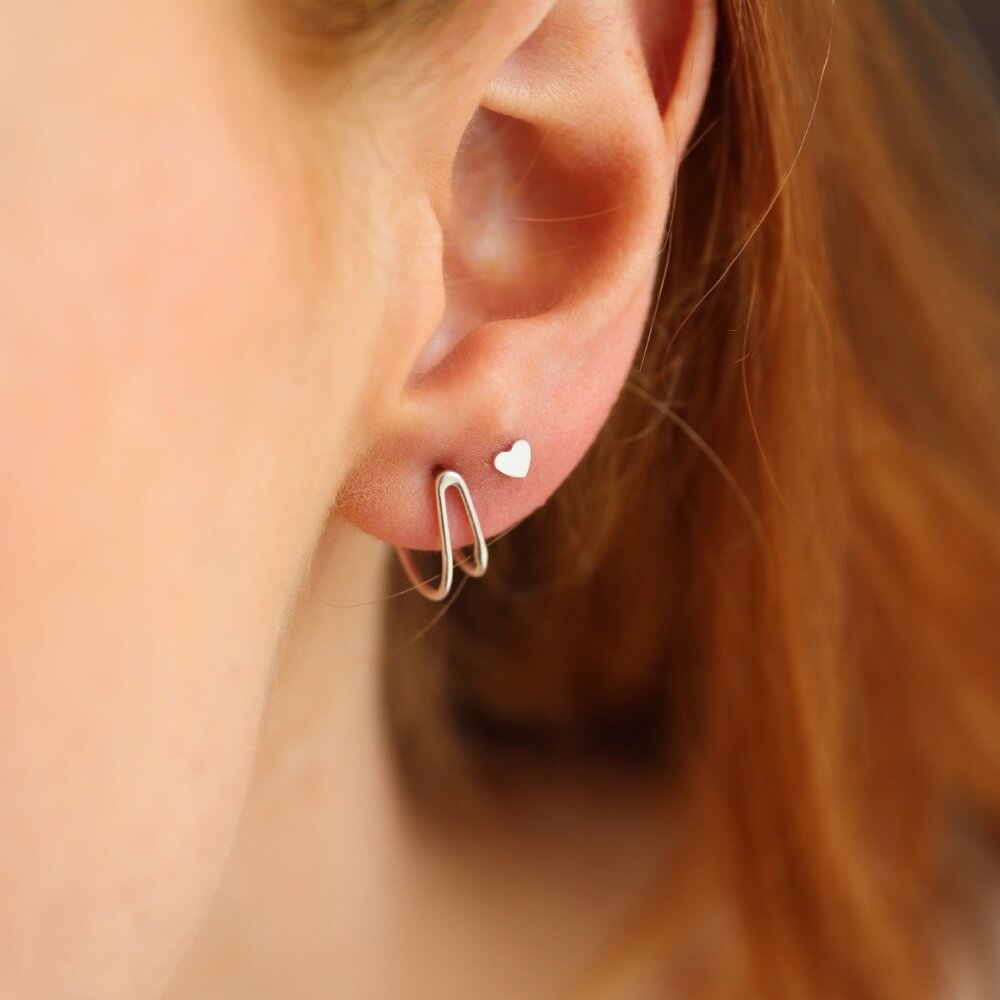 Model Wearing gold fill - sterling silver - wire posts that hug the ear lobe - wishbone shape - locally made in our studio in Eau Claire, WI - Token Jewelry