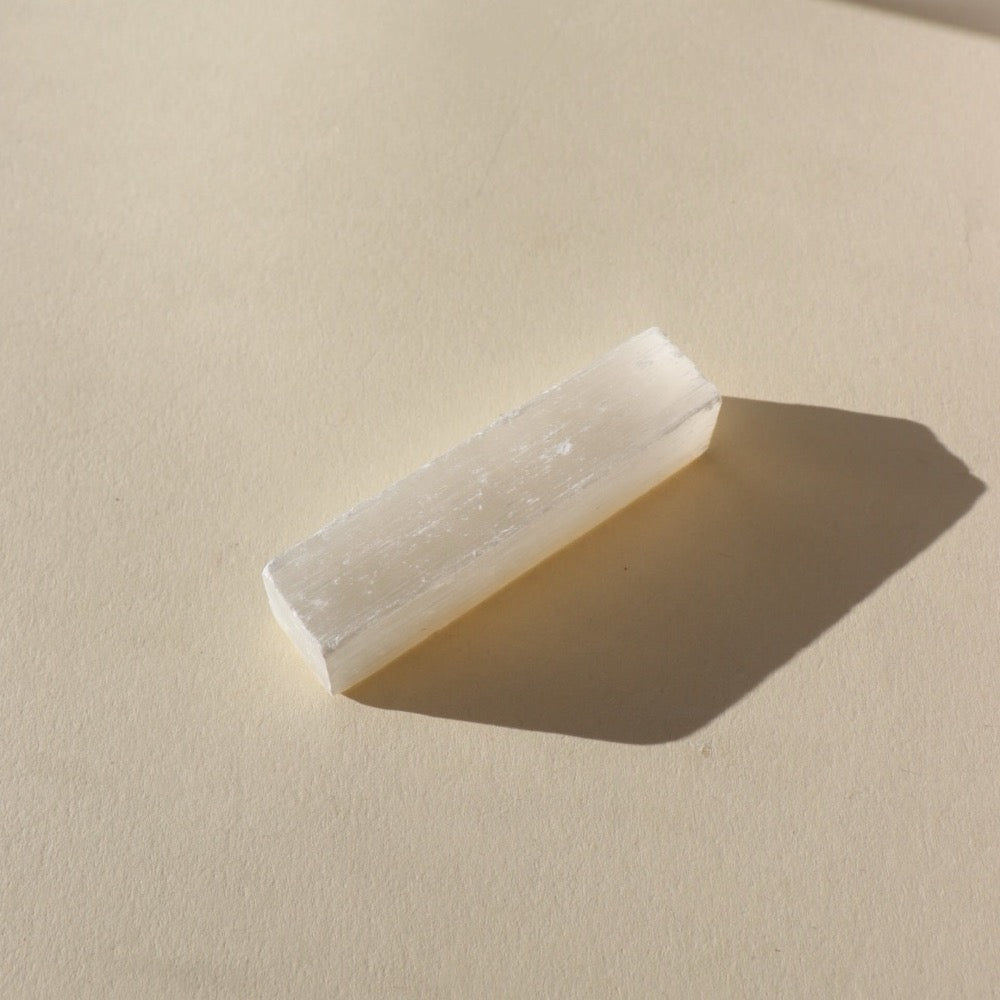 block of selenite stone on a sunny backdrop