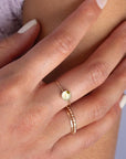 Model wearing Sweet pea ring. This Ring features a smooth band with a prehnite gemstone.