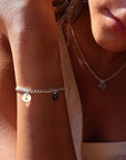 Model wearing 925 sterling silver Carter personalized Disc bracelet. This bracelet features the Carter chain then followed Initial stamped disc.