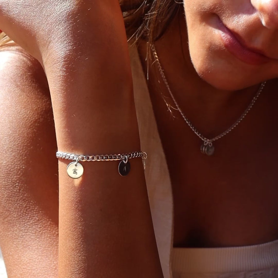 Model wearing 925 sterling silver Carter personalized Disc bracelet. This bracelet features the Carter chain then followed Initial stamped disc.