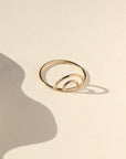 14k gold fill Rainbow Ring placed on cream paper.