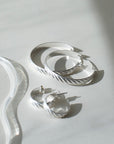 925 sterling silver 3/4" hoop earrings featuring a wave texture photographed on a white tabletop
