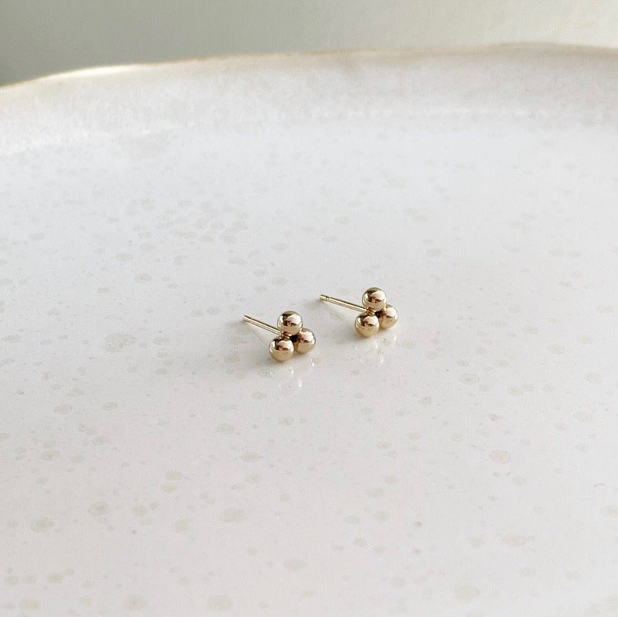 14k gold fill element studs placed on a white plate. Handmade in Eau Claire Wisconsin. Hypoallergenic, nickel free.